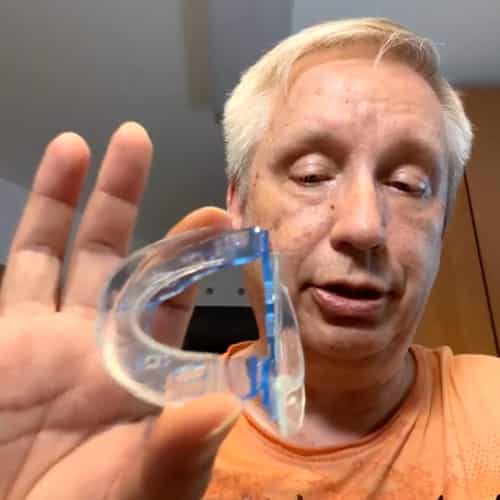 Raj holding a QuietLab anti-snoring mouthpiece