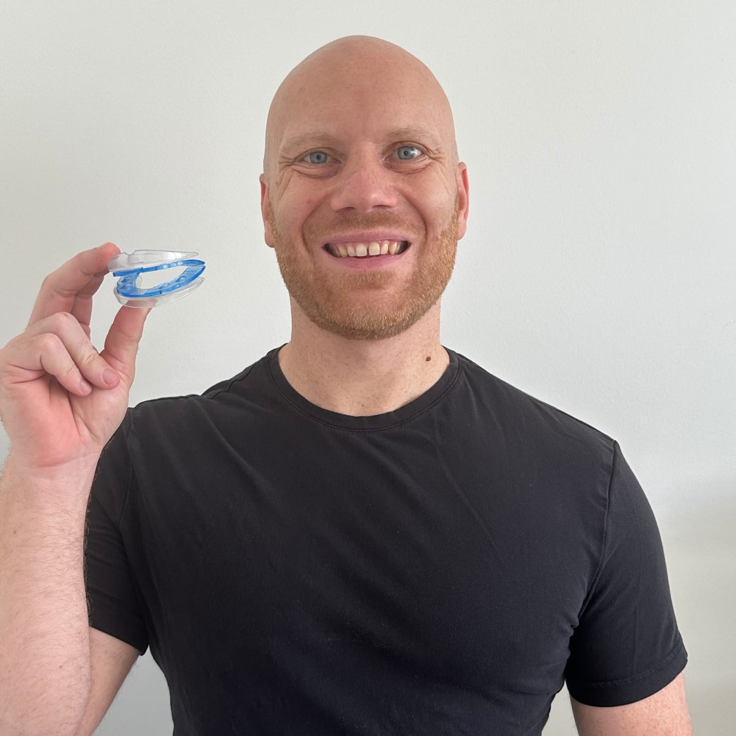 Brian smiling while holding a QuietLab anti-snoring mouthpiece